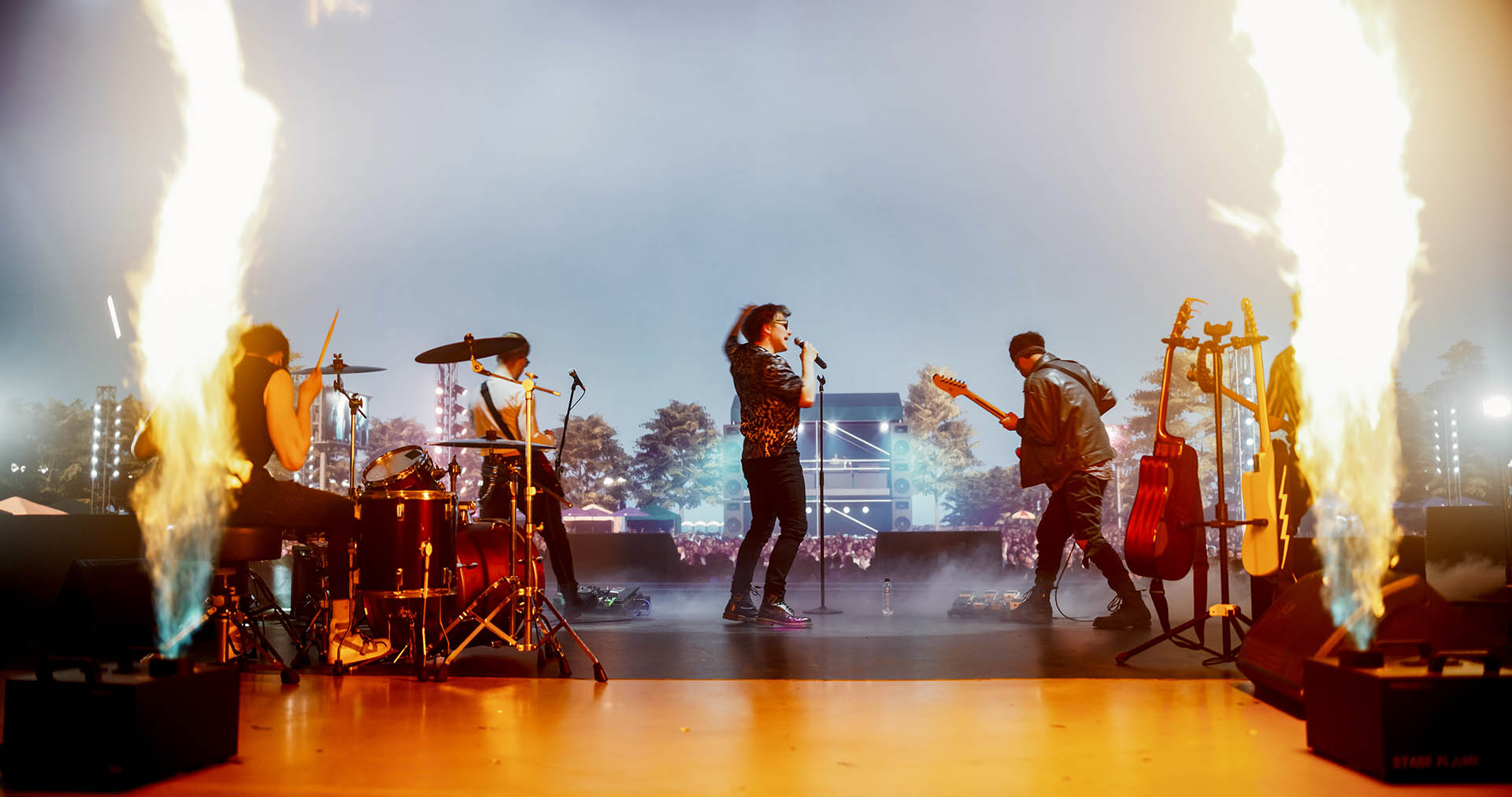Energetic Rock Band Performing on Festival Stage with Fire Pyrot